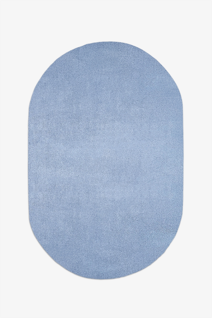 Light baby blue oval rug on a white background