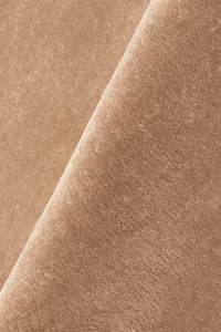 close up texture of a tan light brown hand tufted wool rug