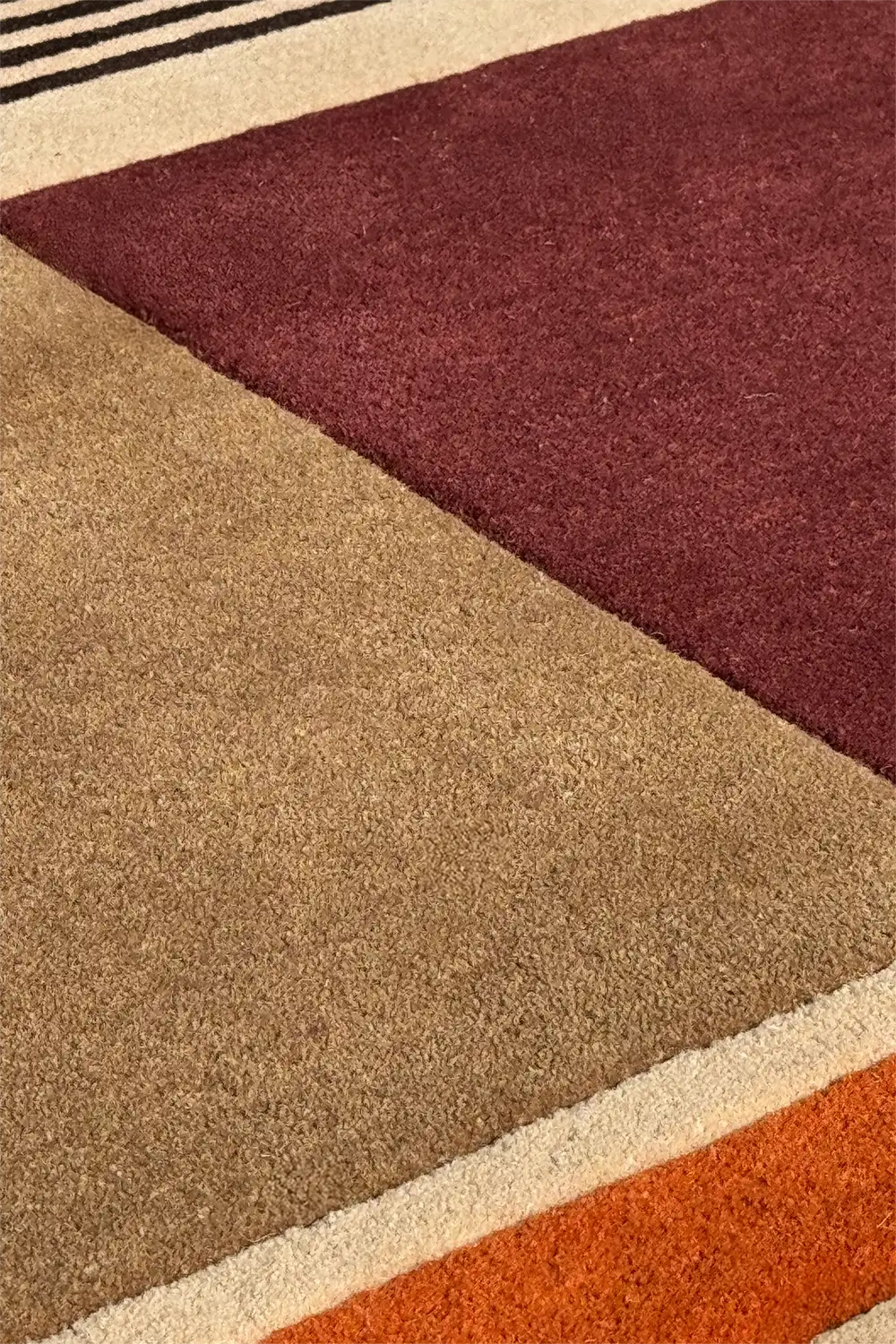 Moody modern color block tufted rug in burgundy, rust, and espresso tones