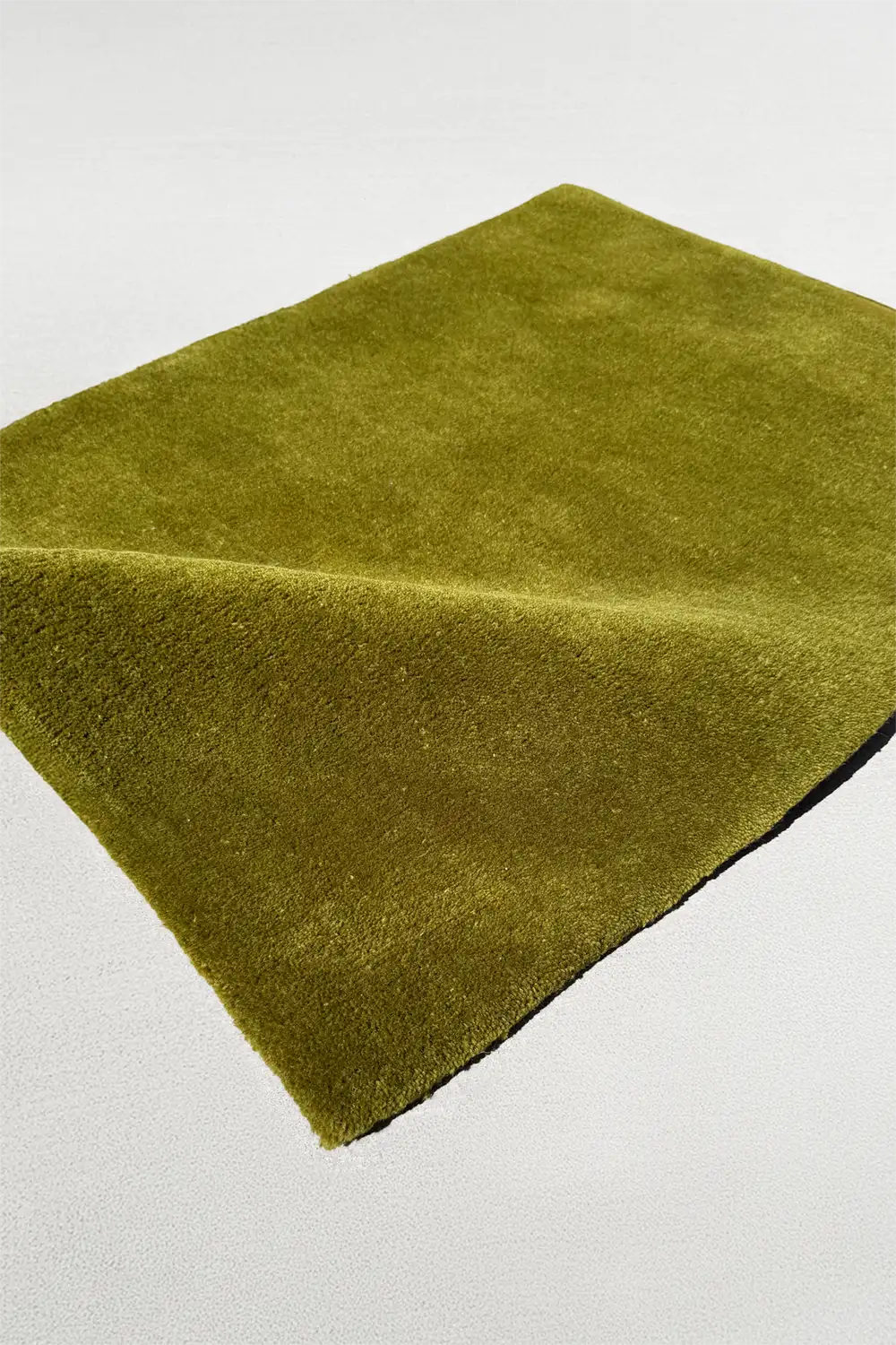 modern olive green rug on a light gray background