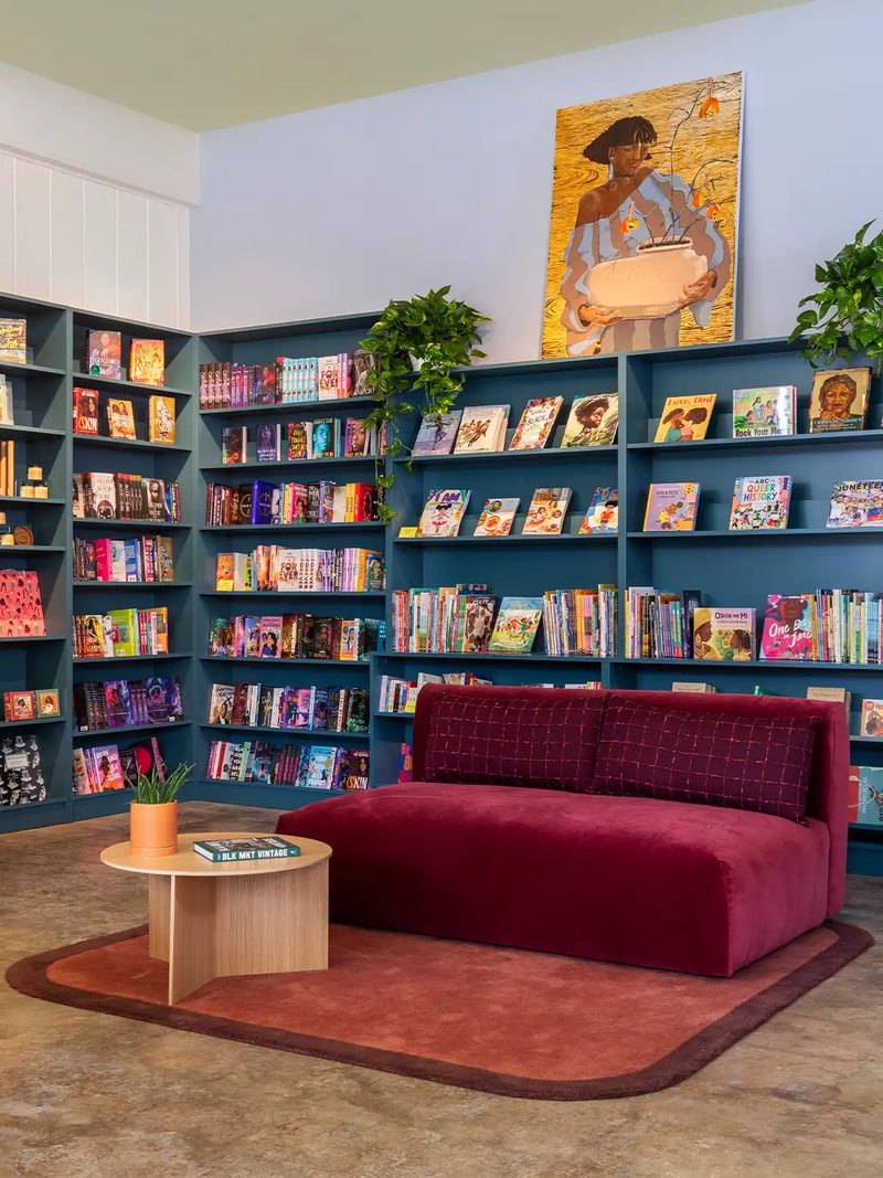 unique brown rug in a modern designer bookstore with large bookshelves and artwork interior