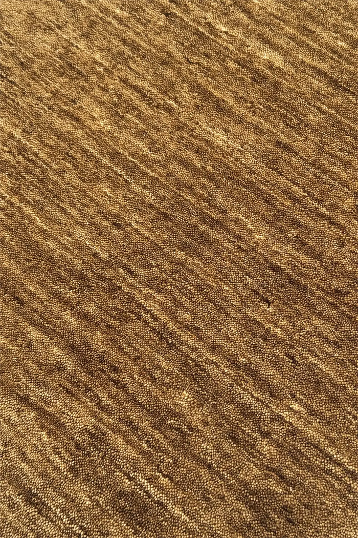 Close-up of modern ochre brown wool hand-loomed rug hazel