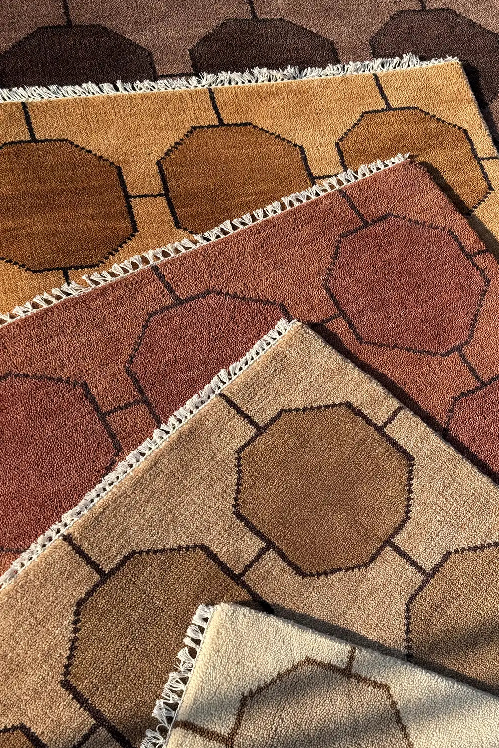 Close-up of patterned rugs with geometric design in ivory brown chestnut walnut taupe honey gold and beige colors lifestyle