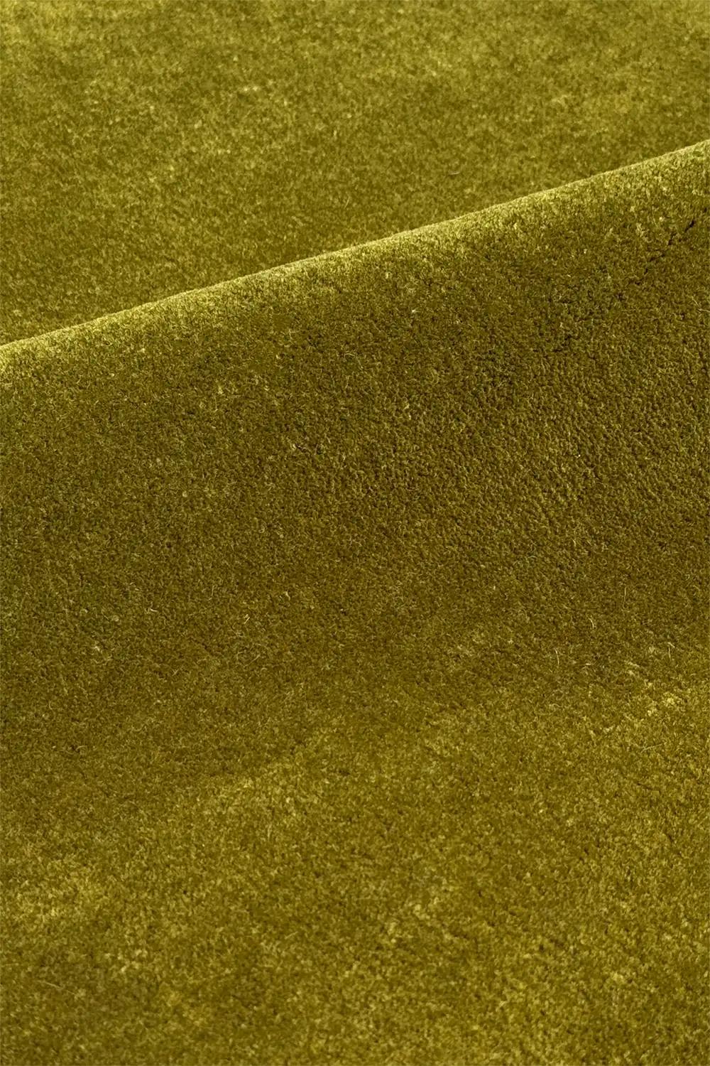 Close-up of textured olive green wool area rug