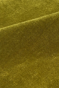 Close-up of textured olive green wool area rug