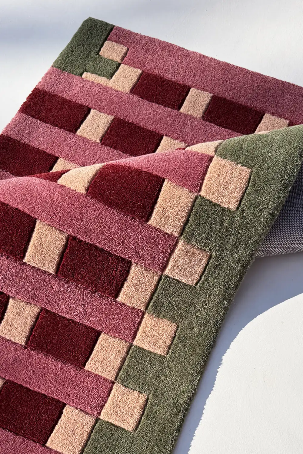 Woven patterned runner rug with geometric design on a white background