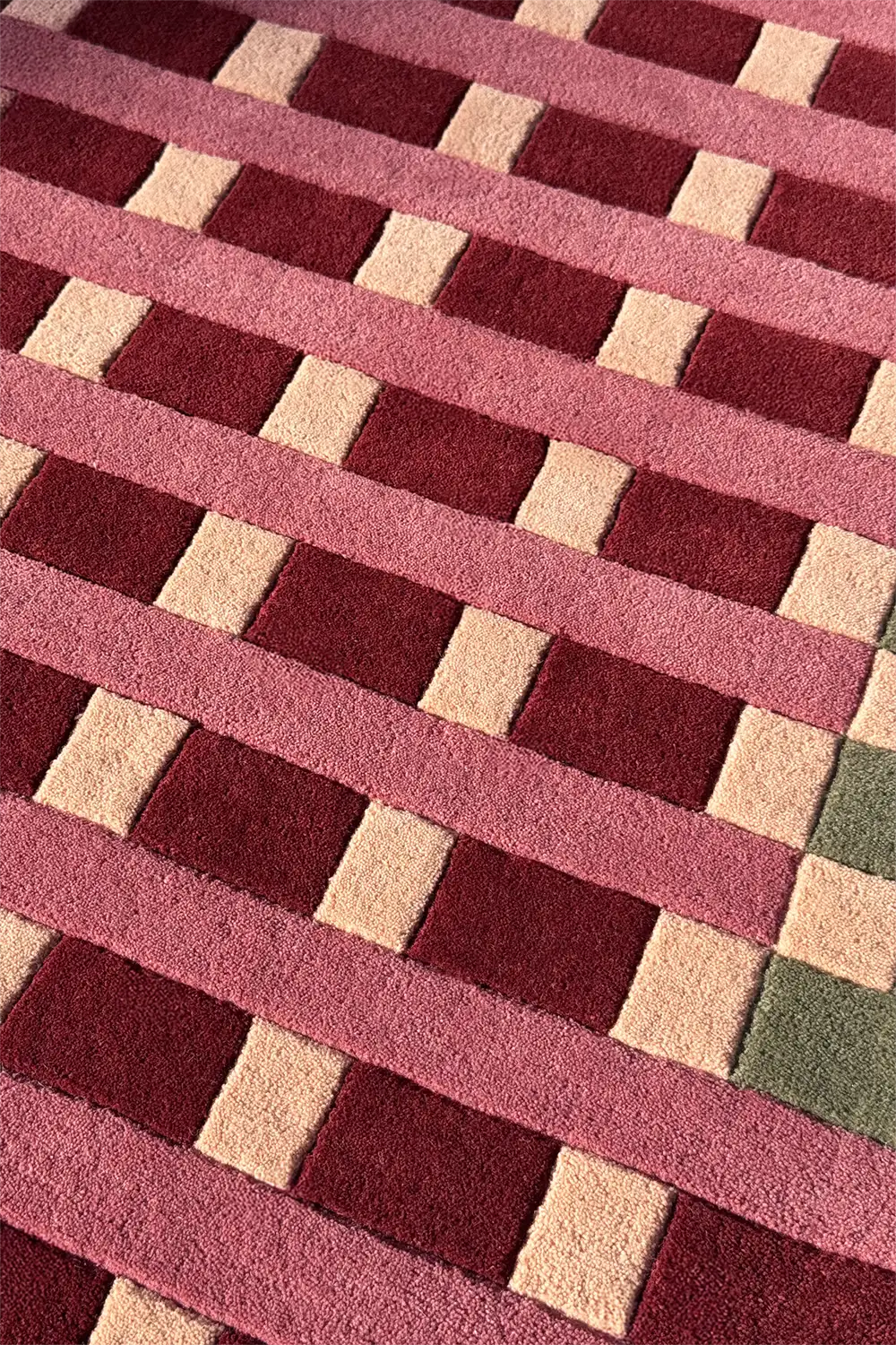Geometric patterned rug with red and beige squares