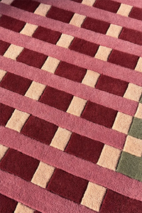 Geometric patterned rug with red and beige squares