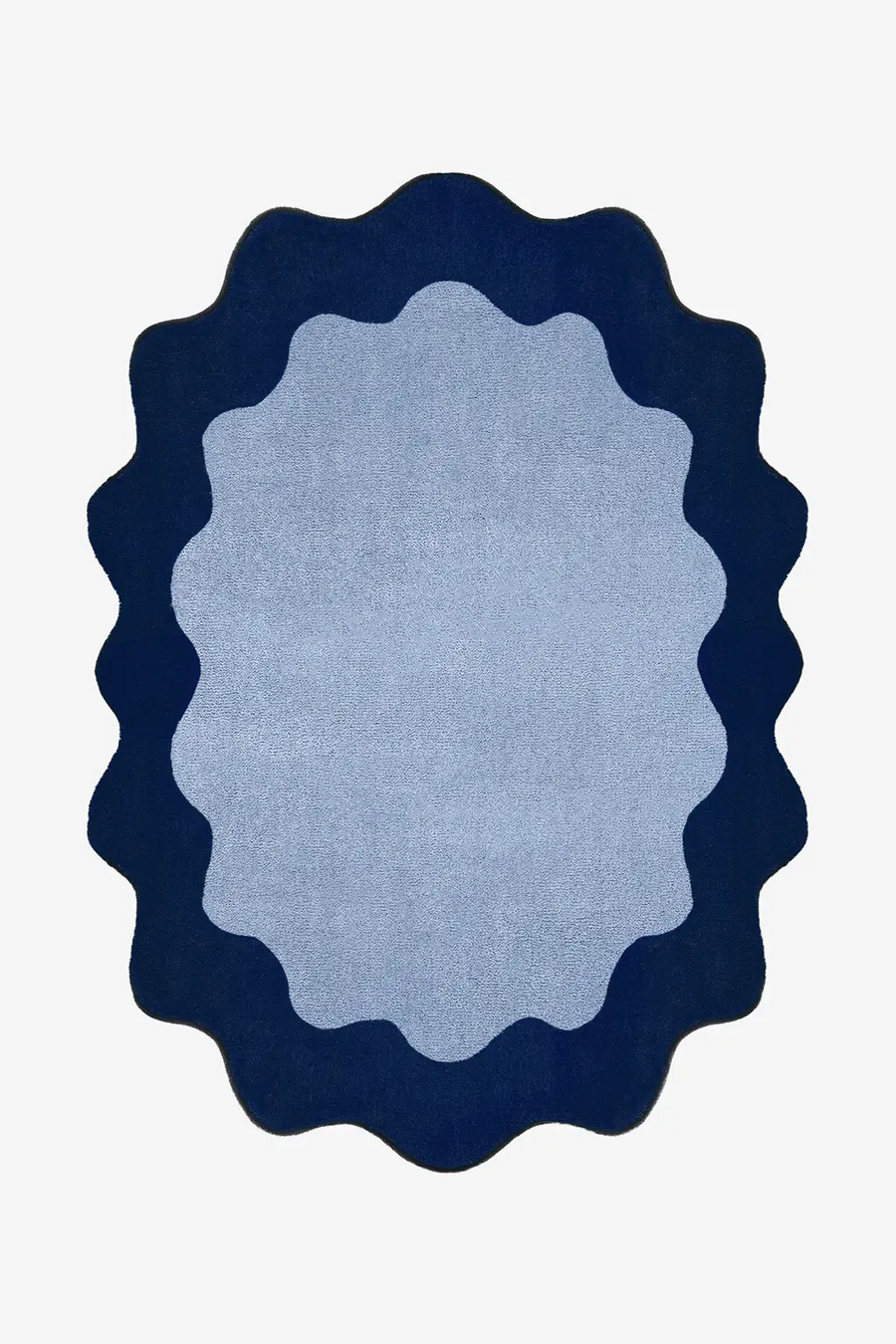 oval blue rug with navy scalloped edge on a white background