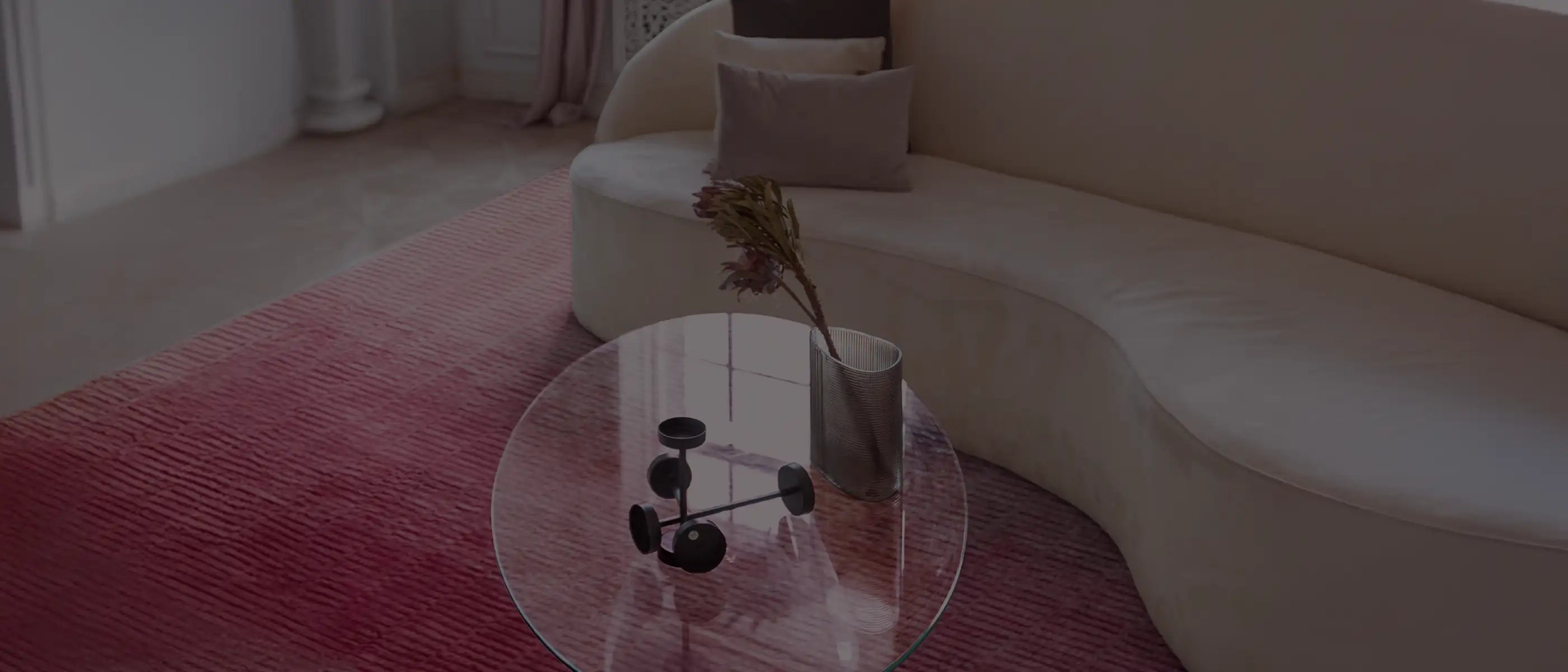 pink ombre loomed rug in a contemporary living room with sculptural furniture