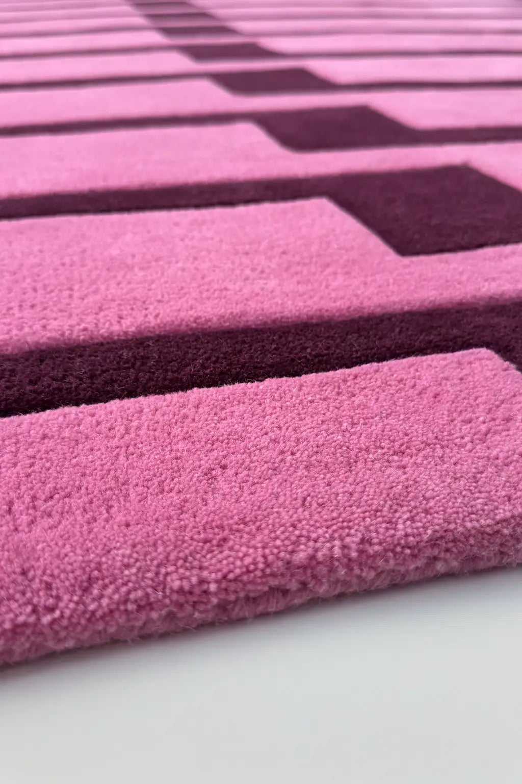Close-up of a pink and purple striped runner rug texture