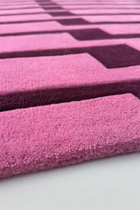 Close-up of a pink and purple striped runner rug texture