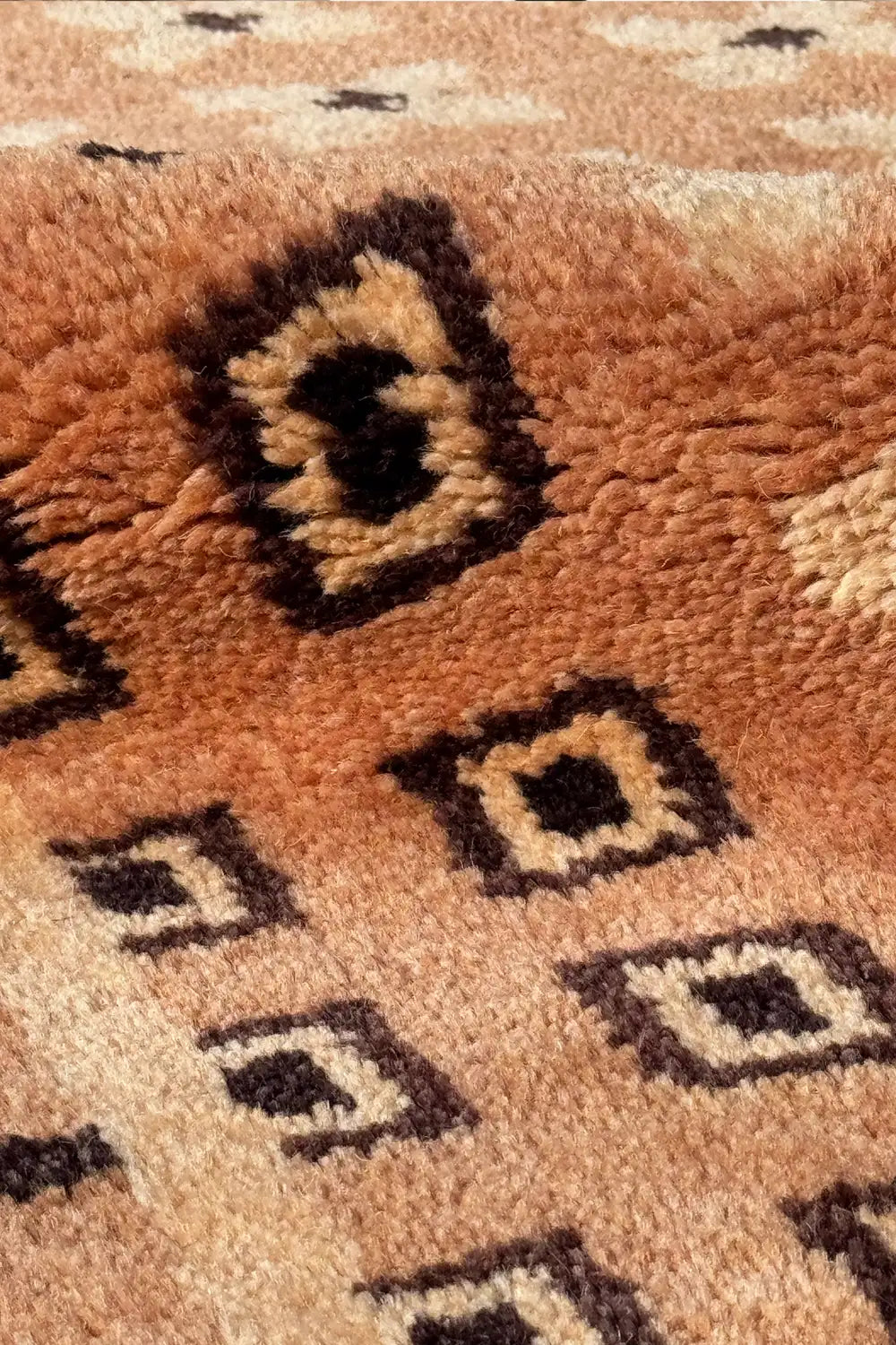 Soft wool texture of modern brown rug with raised geometric design, handwoven mid-century modern area rug