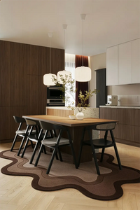 Modern kitchen with wooden dining table and chairs on a decorative organic shaped brown rug lifestyle