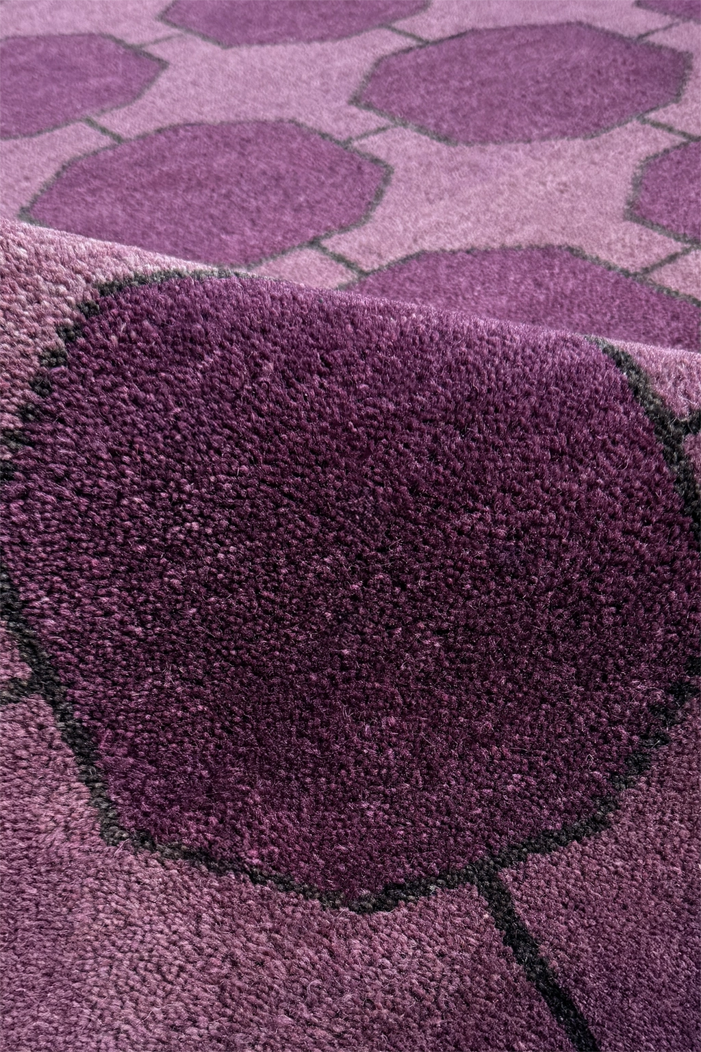 Close-up of a purple rug with geometric patterns texture