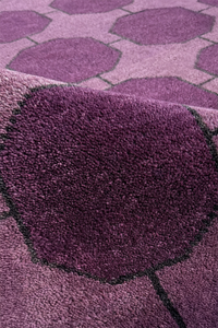 Close-up of a purple rug with geometric patterns texture