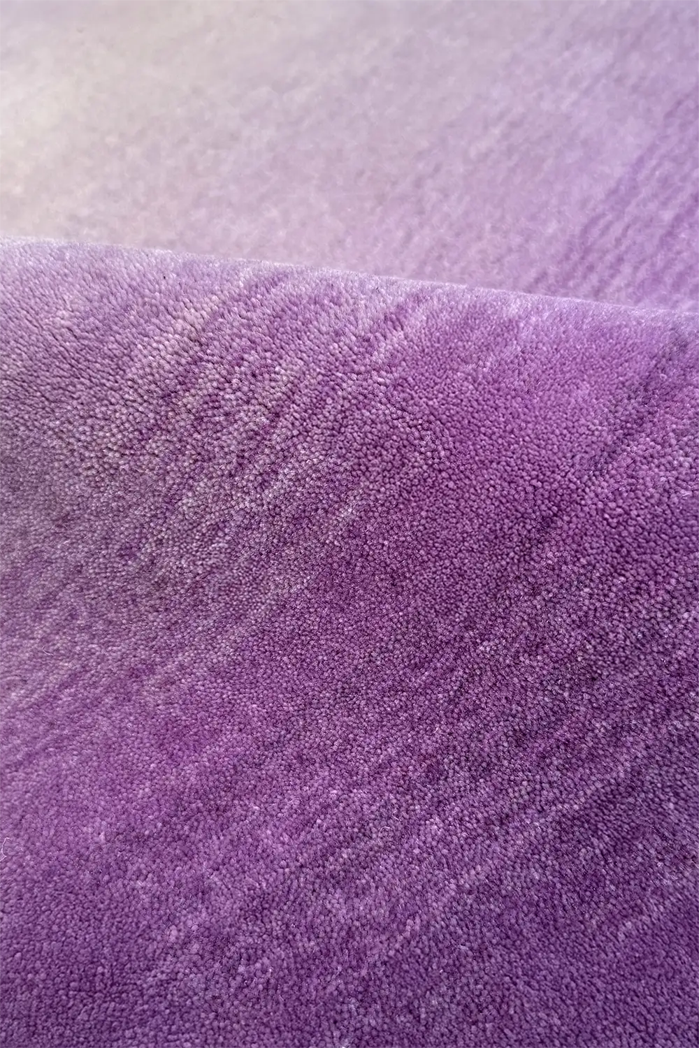 Close-up of purple ombre hand loomed wool modern rug