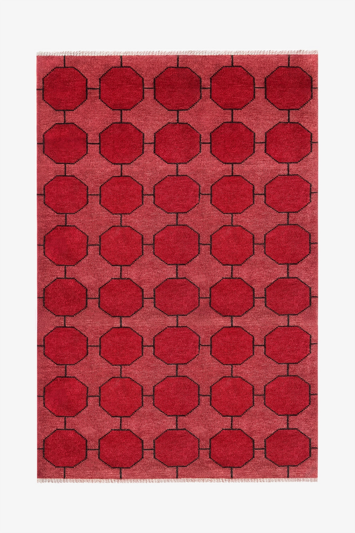 Red geometric patterned rug on a white background | 5x8