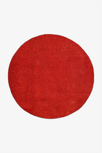 Red round wool rug on a white background