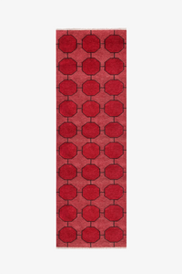 Red runner rug with a bold geometric pattern on a white background