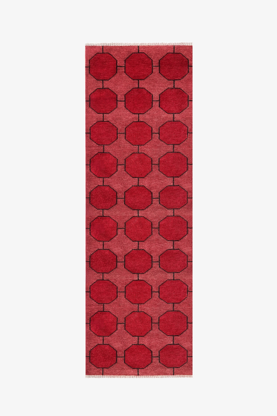 Red runner rug with a bold geometric pattern on a white background