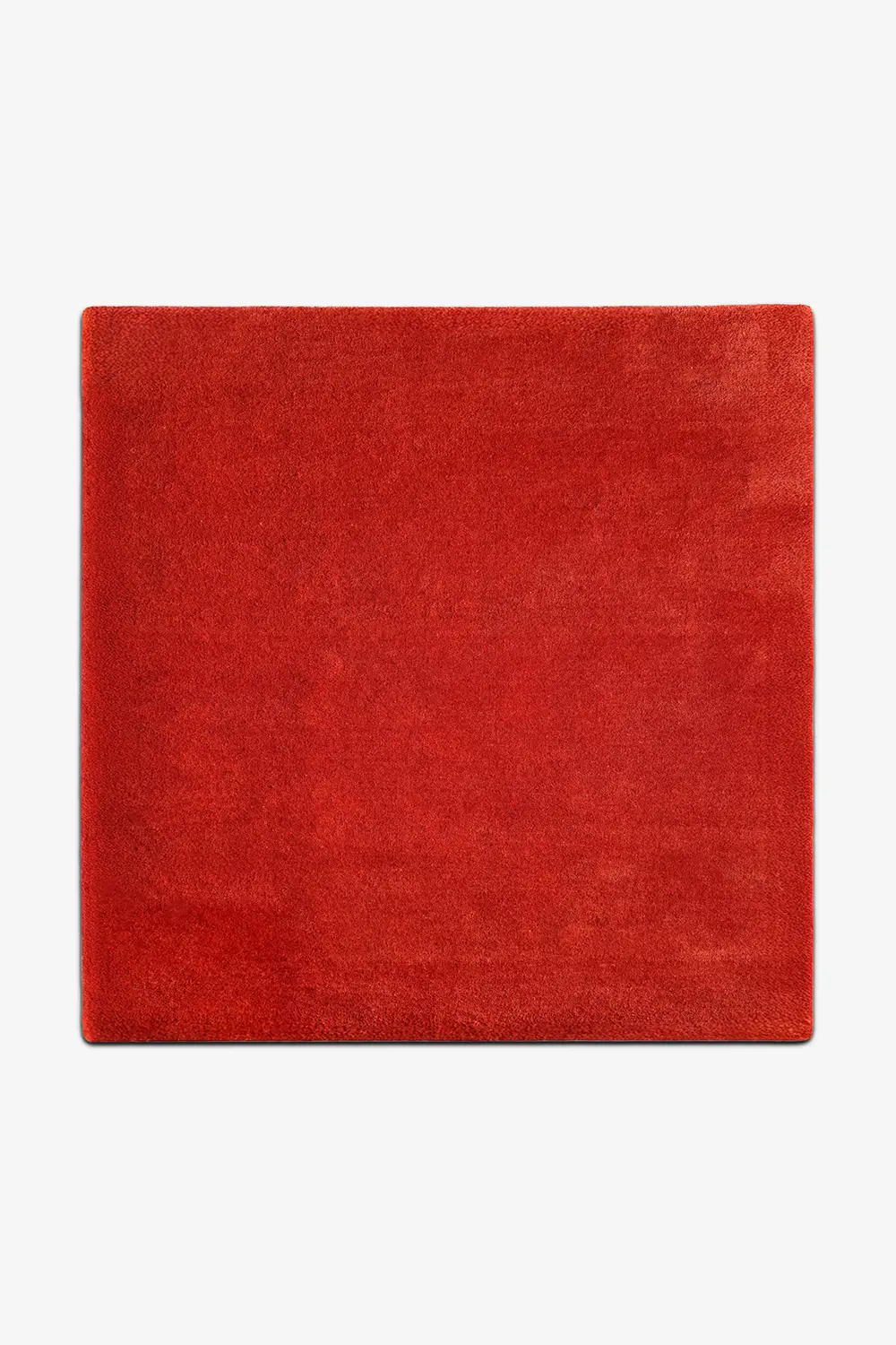 Red square wool rug on a white background