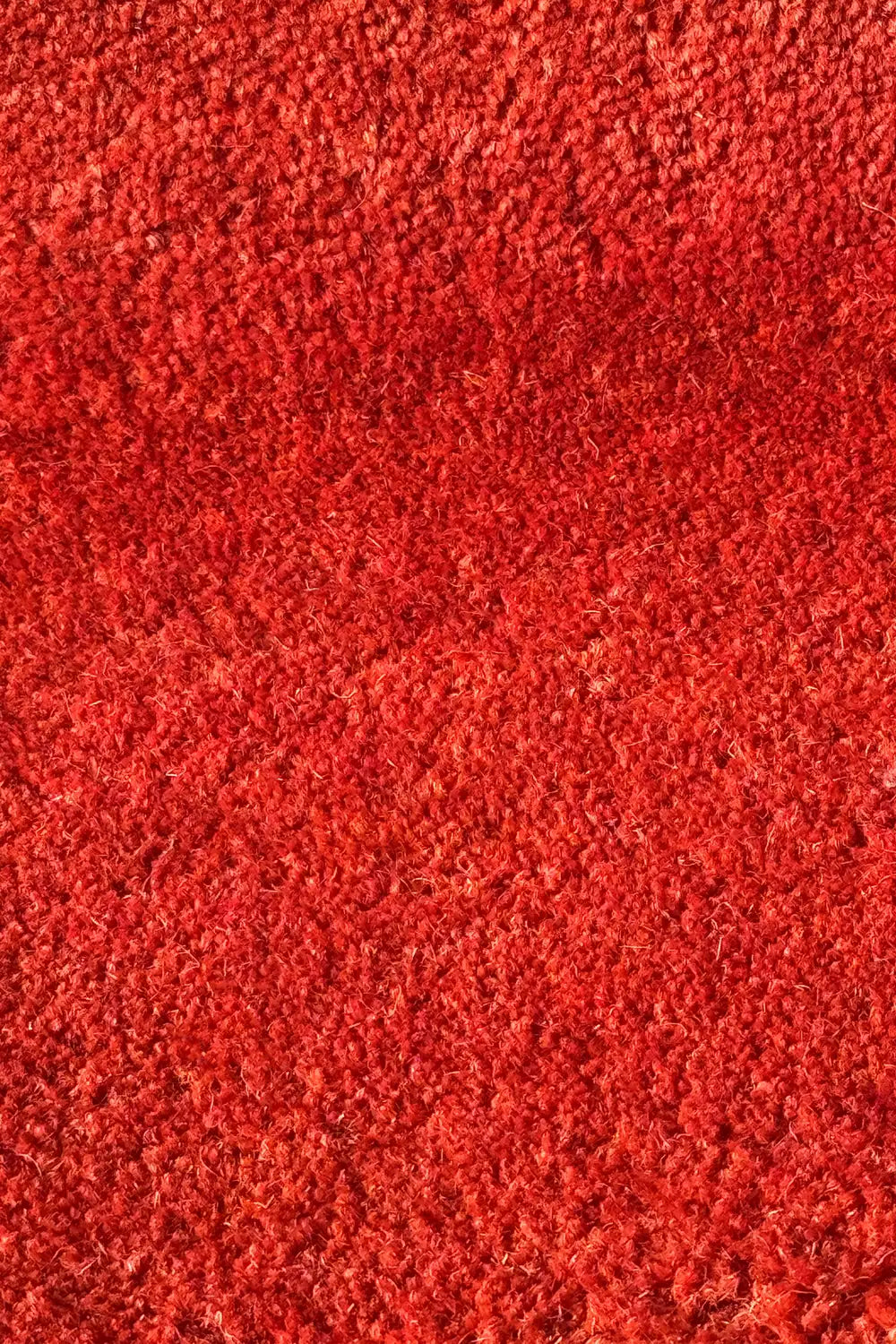 Close-up of a red wool textured rug