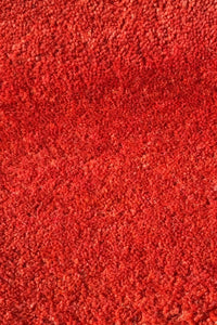 Close-up of a red wool textured rug