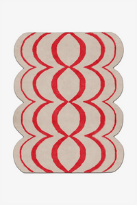 Red and white geometric patterned rug on a white background