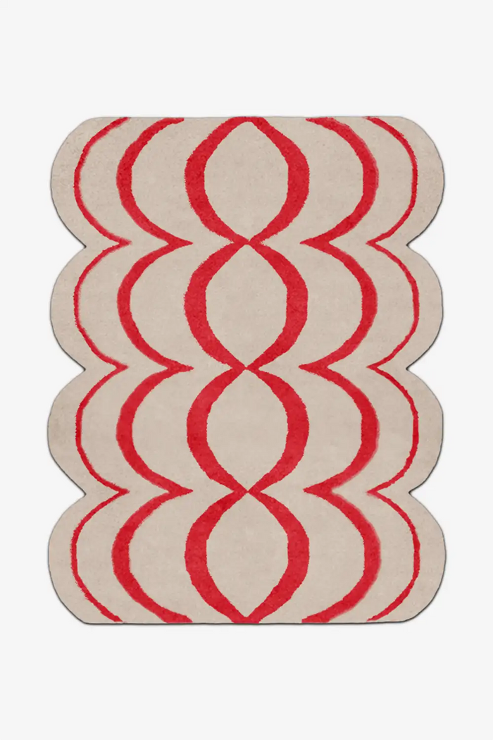 Red and white geometric patterned rug on a white background