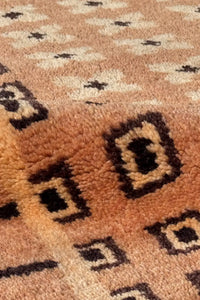 Plush wool texture on hand knotted square rug with taupe background and black geometric accents, ideal for MCM interiors
