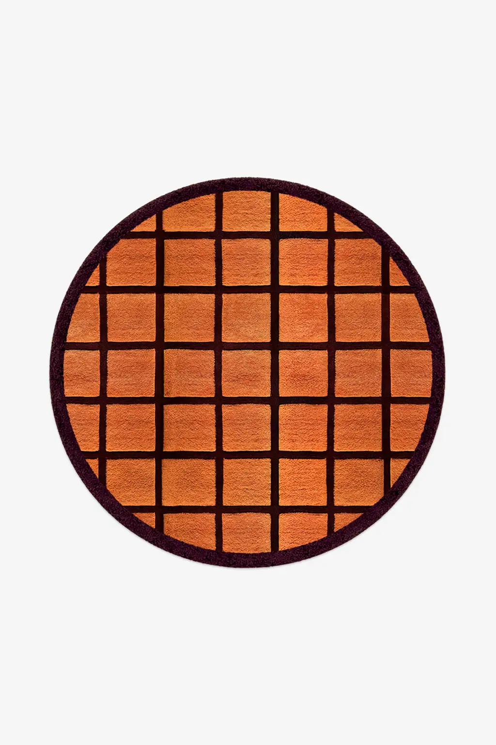 Round orange rug with burgundy grid pattern on a white background