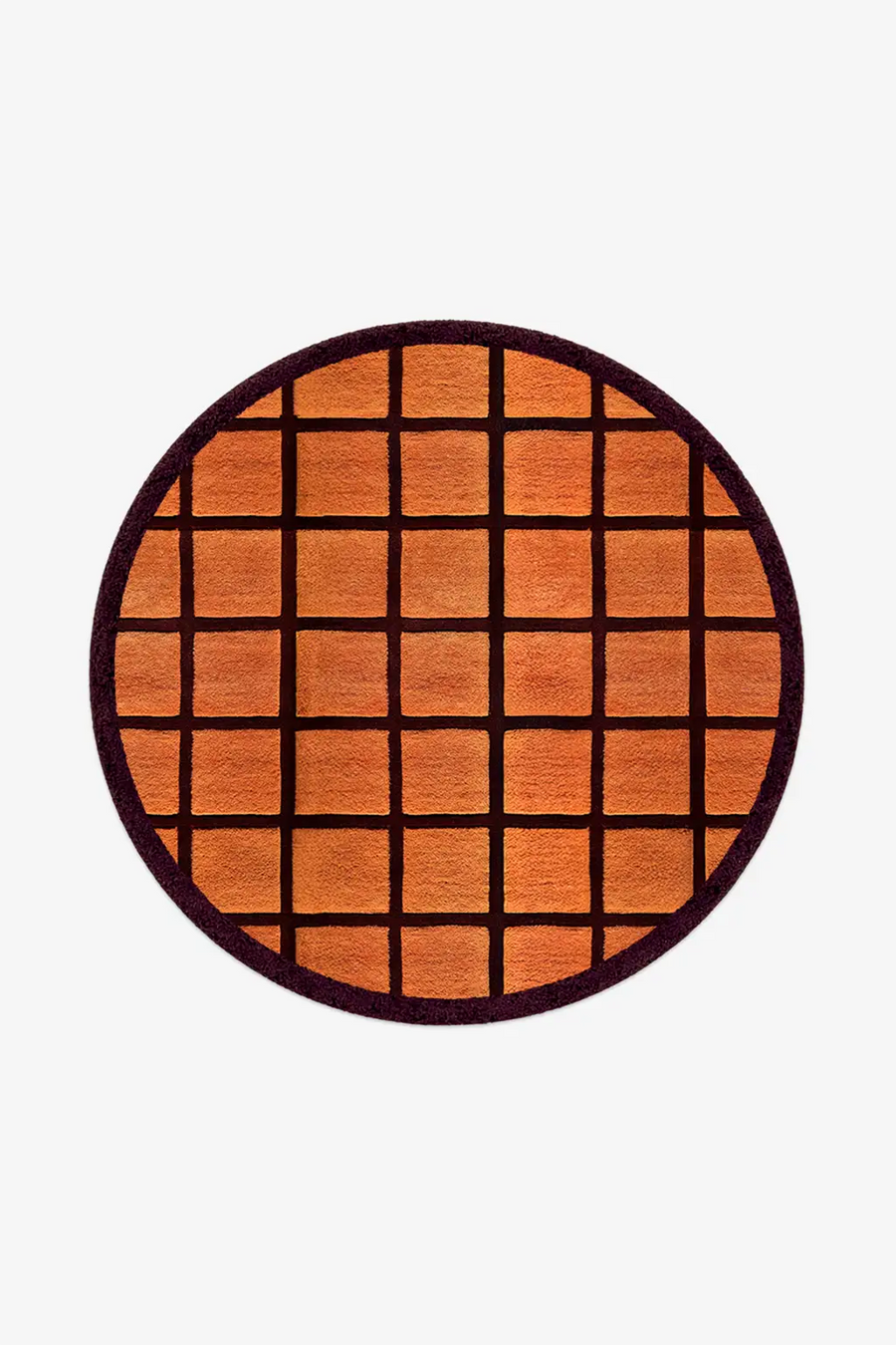 Round orange rug with burgundy grid pattern on a white background