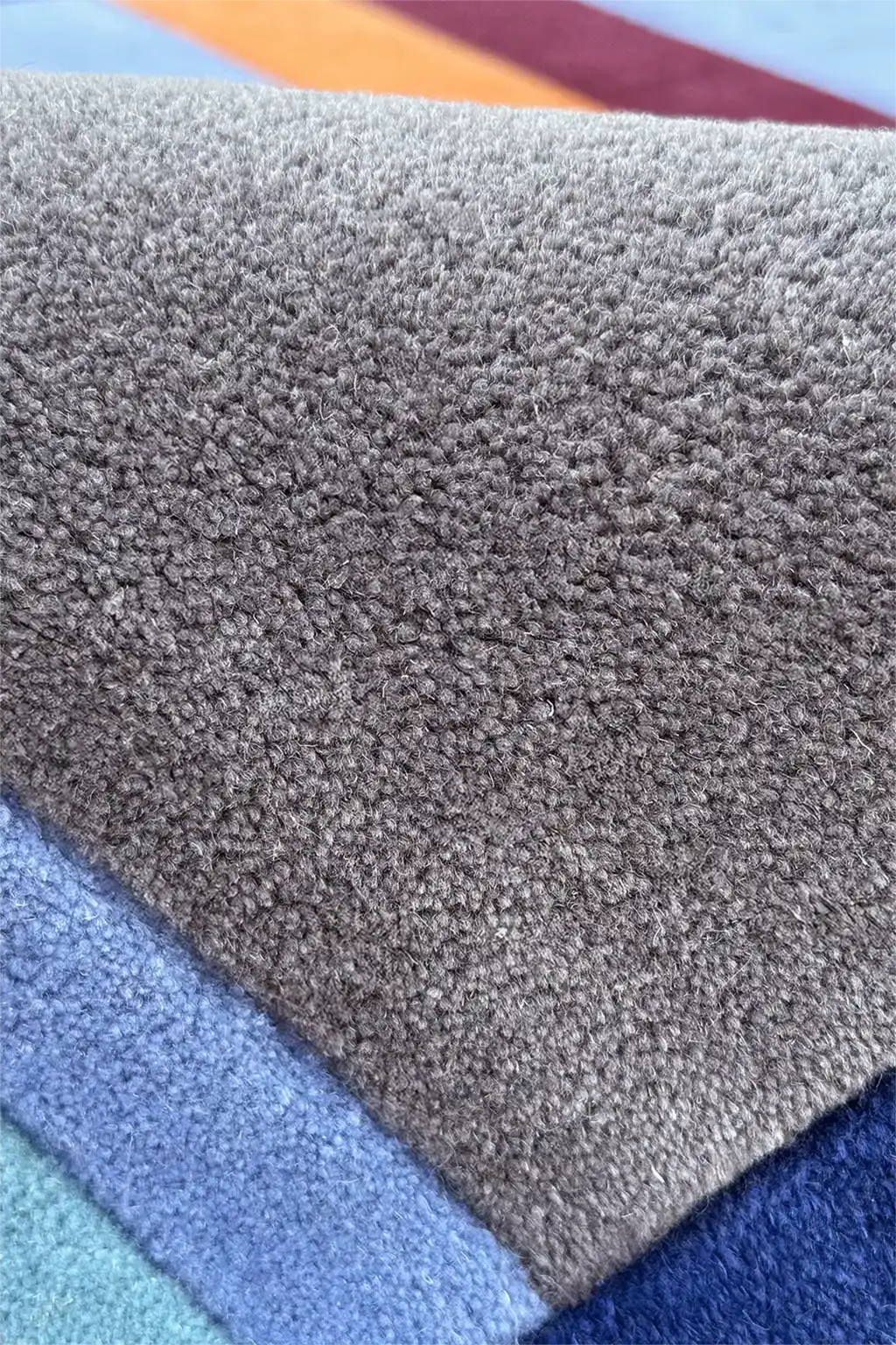 Close-up of textured rug pile in various colors
