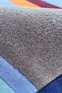 Close-up of textured rug pile in various colors