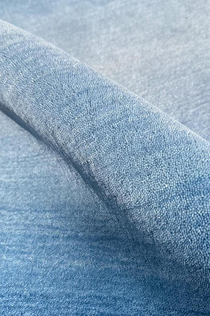 Close-up of textured blue wool runner rug