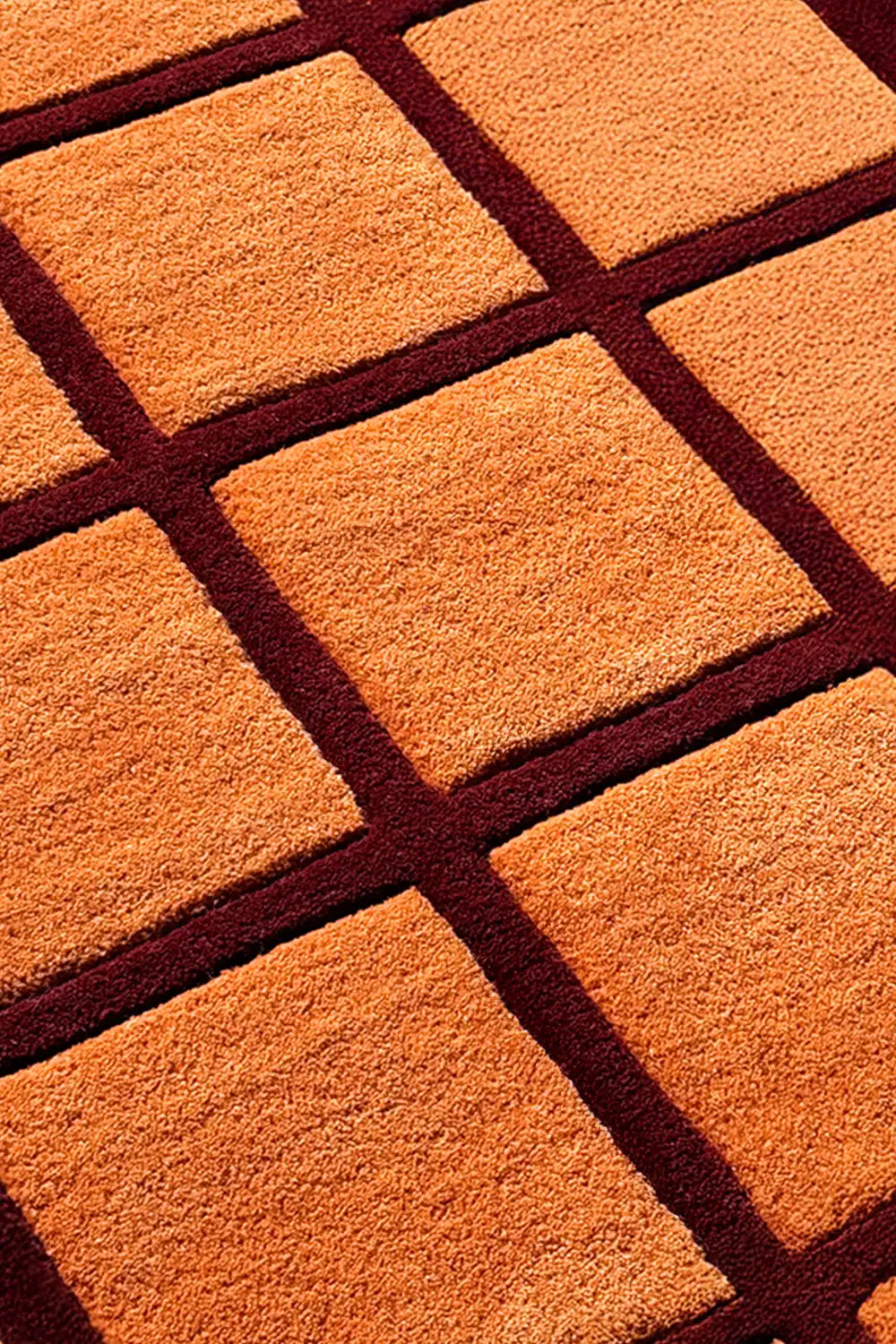 close up texture of orange and reg checkered runner rug 