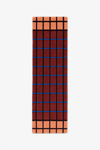 runner rug with a rust and terracotta grid pattern on a white background