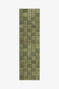 olive green checkered runner rug on a white background
