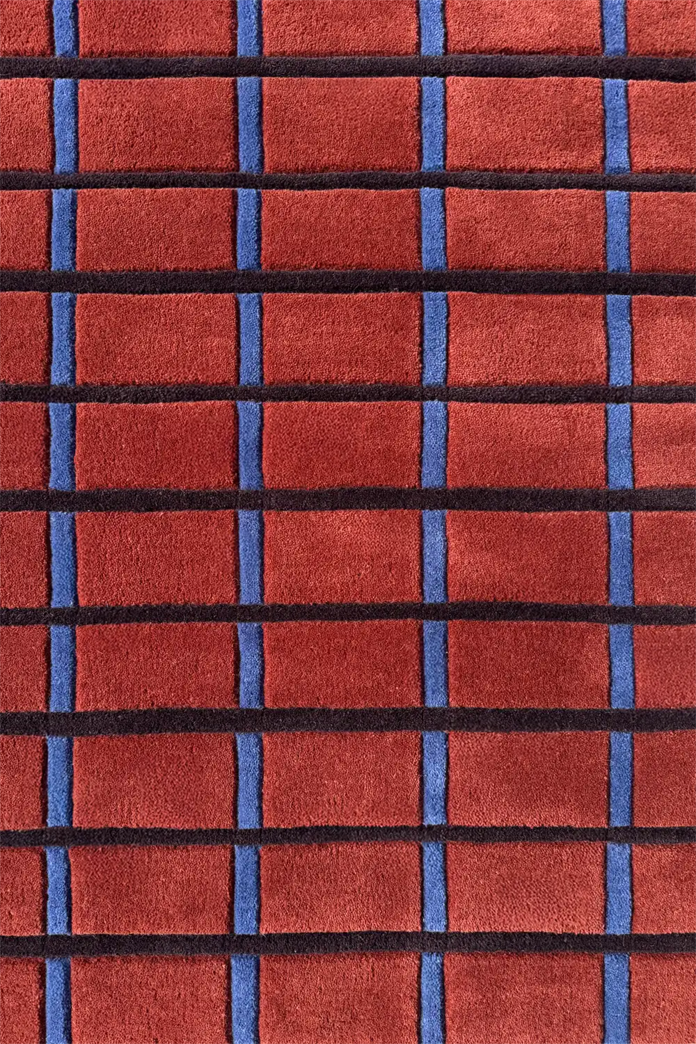 rust, blue, and black grid pattern on a wool hand tufted area rug