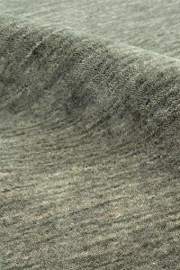 Close-up of textured sage green modern wool area rug