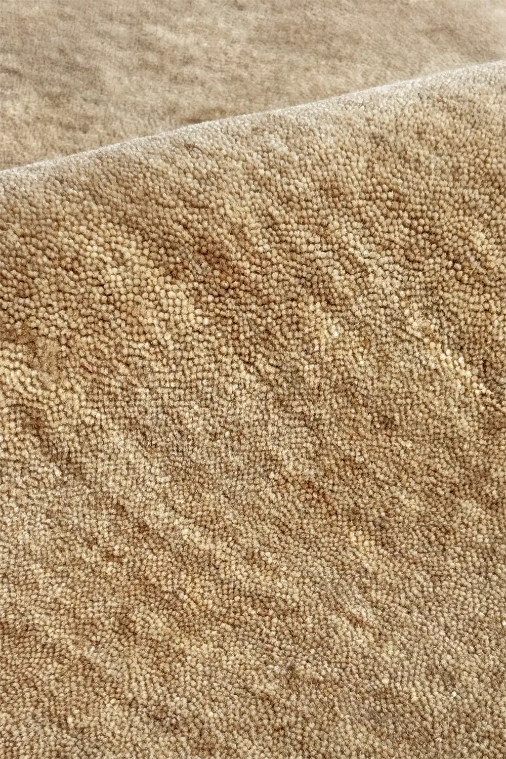 Close-up of soft beige wool carpet texture
