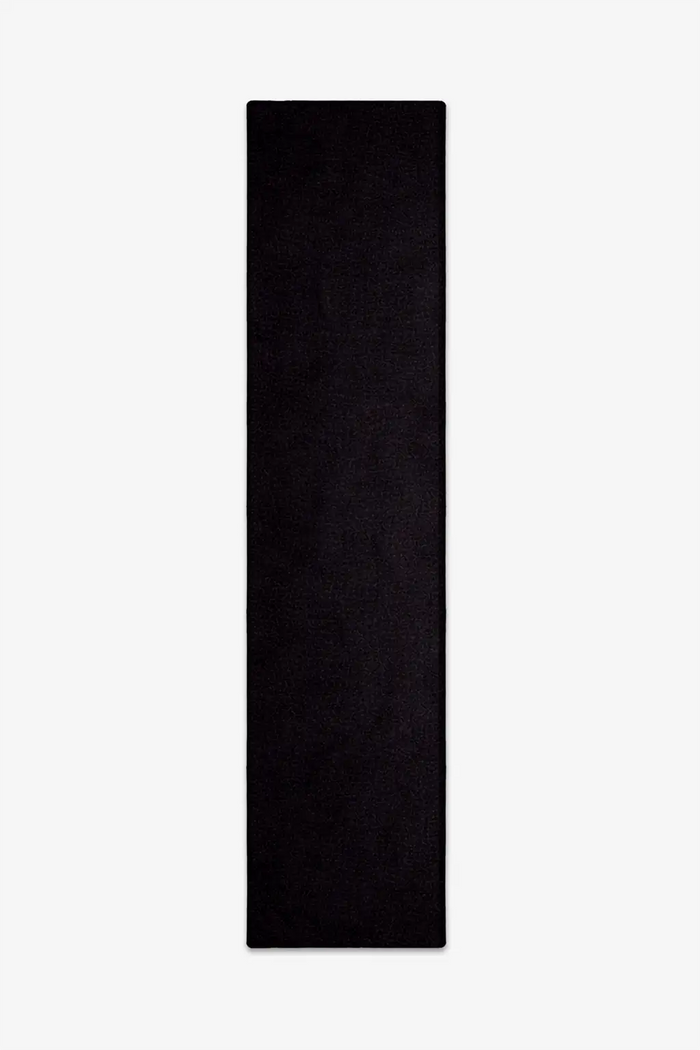 solid black wool runner rug on a white background