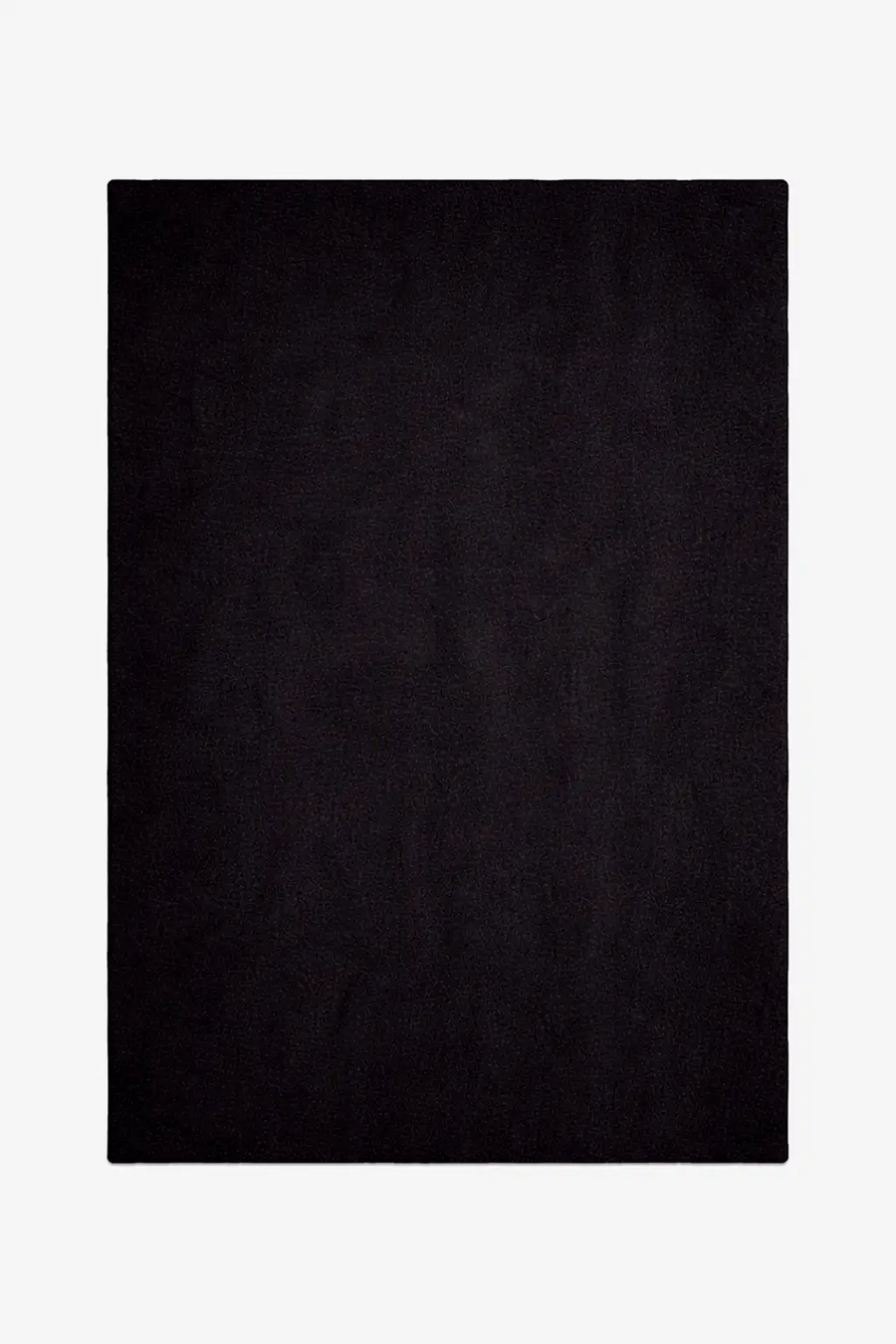 Solid black wool rug on a white background