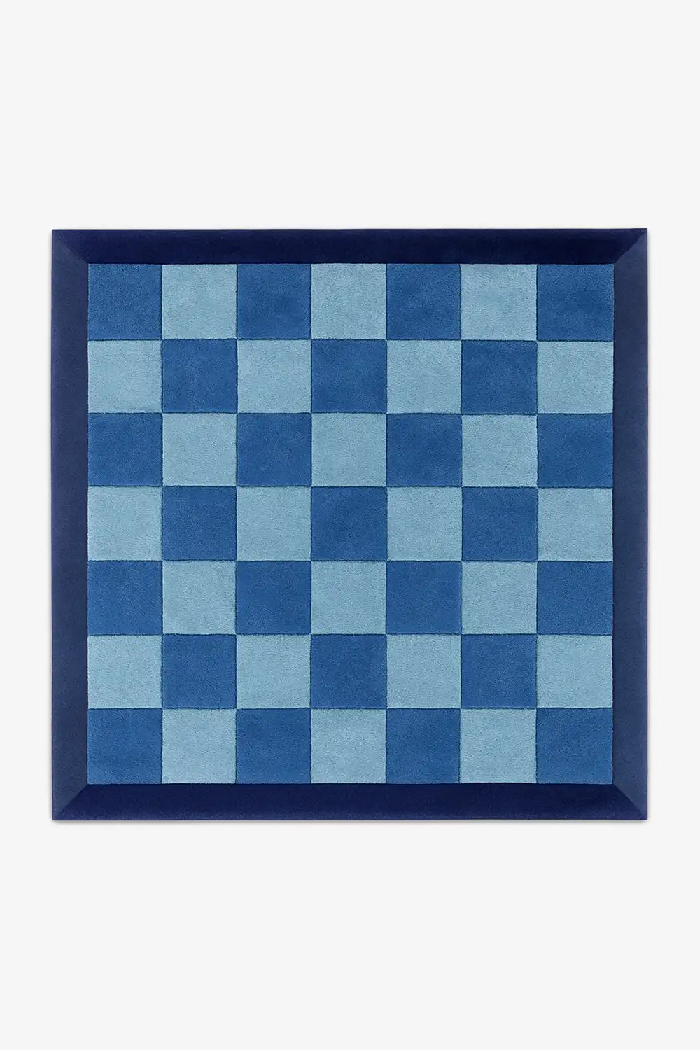 square rug with blue and light blue checkered pattern with a deep navy border in wool on a white background