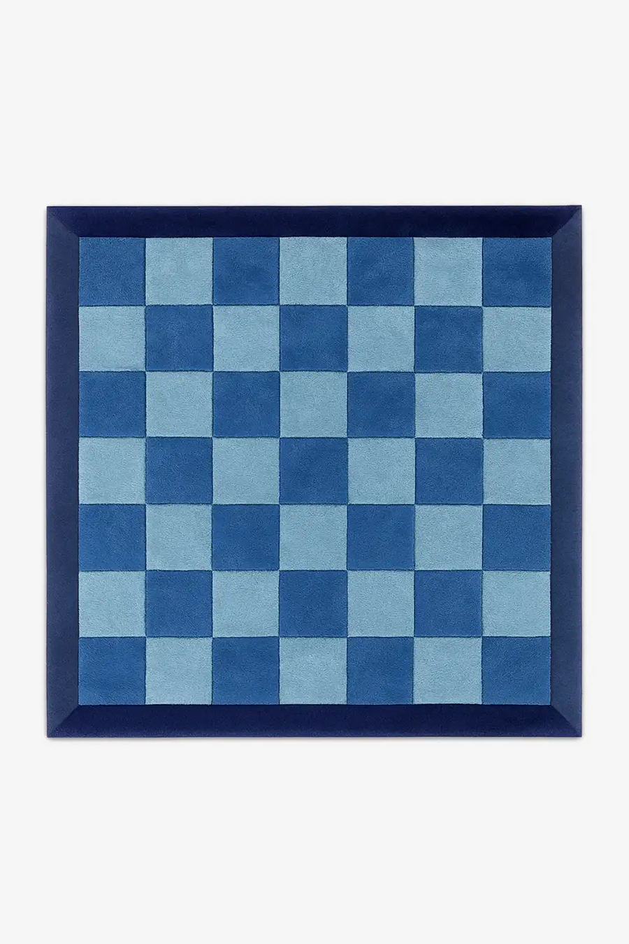 square rug with blue and light blue checkered pattern with a deep navy border in wool on a white background
