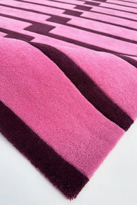 Close-up of a pink and purple striped square rug texture