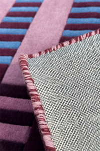 Close-up of square wool rug with striped and textured patterns