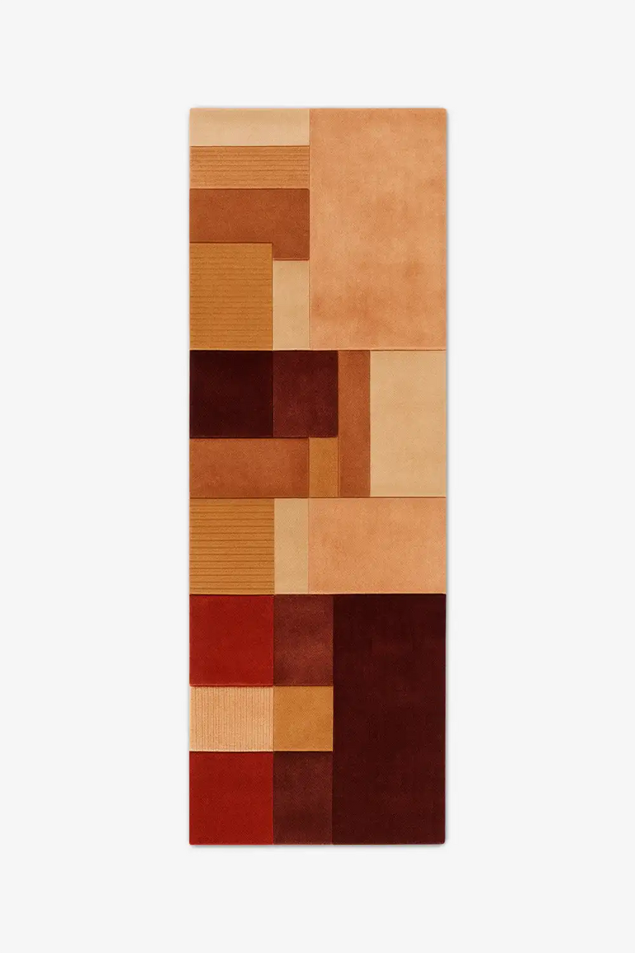 modern wool runner rug with a patchwork design in brown, orange, and red on a white background
