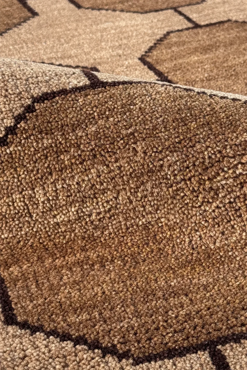 Close-up of a taupe neutral hand-knotted wool textured carpet